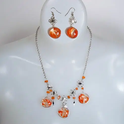 A picture of the alpaca three moons set, made from glass gems, and the glass gems have orange with in them.