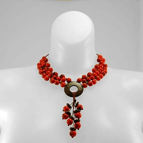 A picture the knotted seed and coco disc necklace has colorful acai and coconut beads.