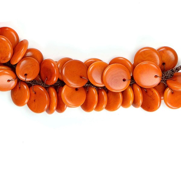 A close up picture of the orange tagua crocheted necklace.