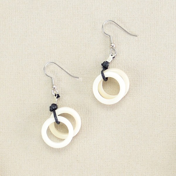 A close up of the white helix earrings.