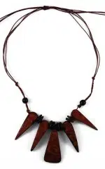 A picture of a necklace that has five large tooth like, made from coconut.
