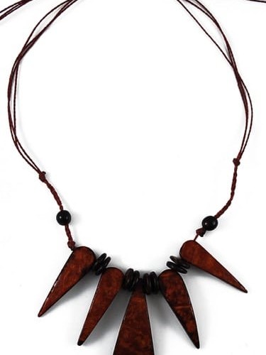 A picture of a necklace that has five large tooth like, made from coconut.