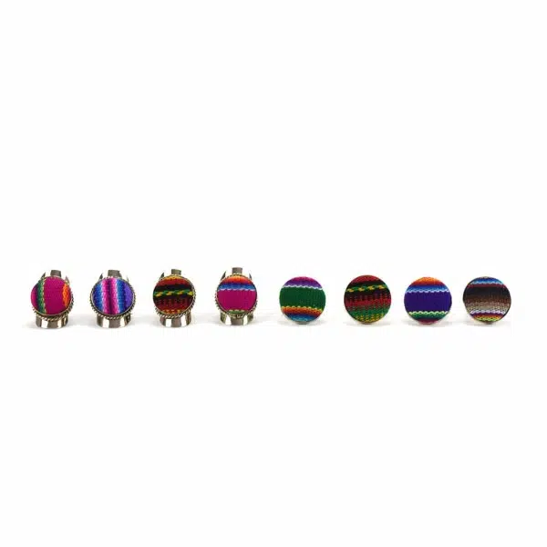A picture of eight different textile rings, With a verity of designs that have been made out of woven fabric.