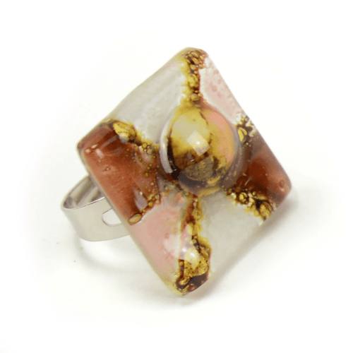 A close up picture of the white and brown art glass ring.