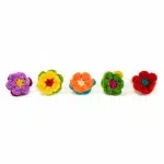 Five brightly colored rings that have hand crocheted flowers on top.