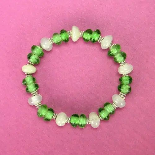broken glass is melted down in to beads and then turned into this bracelet, all held together on a strand of elastic.