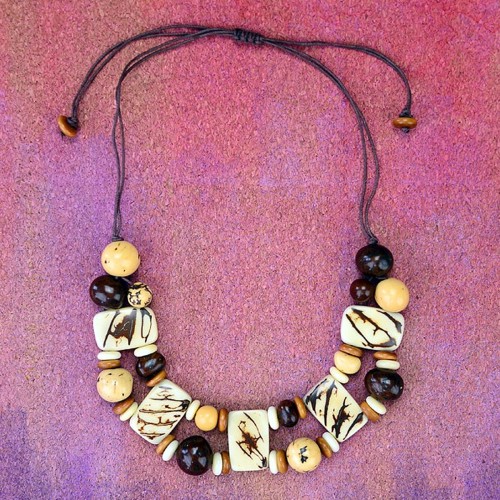 A natural plaque necklace made from tagua and pambil beads.