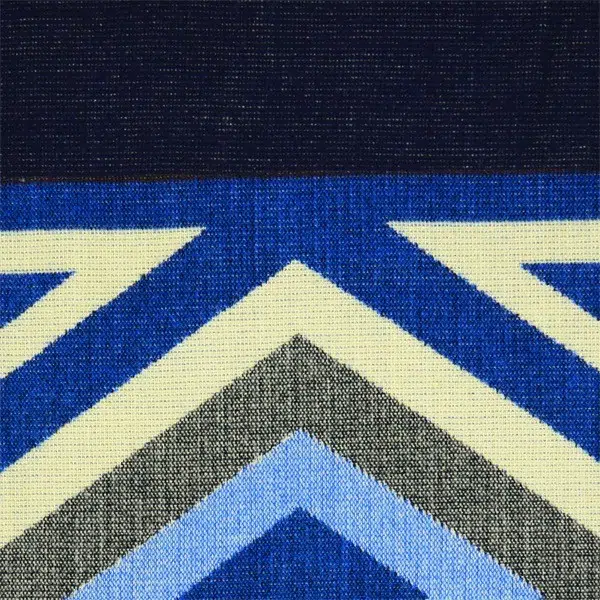 A close up of the comodo poncho, showing colors and designs, this one is dark blue, blue, and white