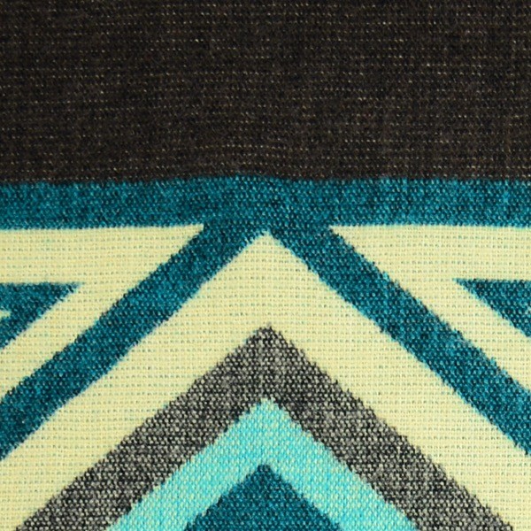 A close up of the comodo poncho, showing colors and designs, this one is black, blue, and white
