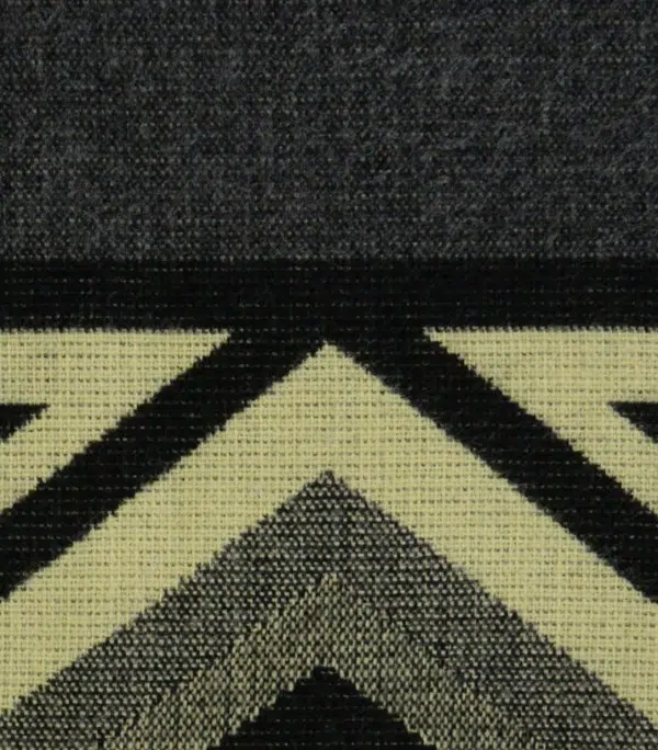 A close up of the comodo poncho, showing colors and designs, this one is Grey, black, and white