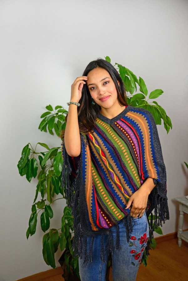 A young women wearing aurora alpaca poncho available in several colors