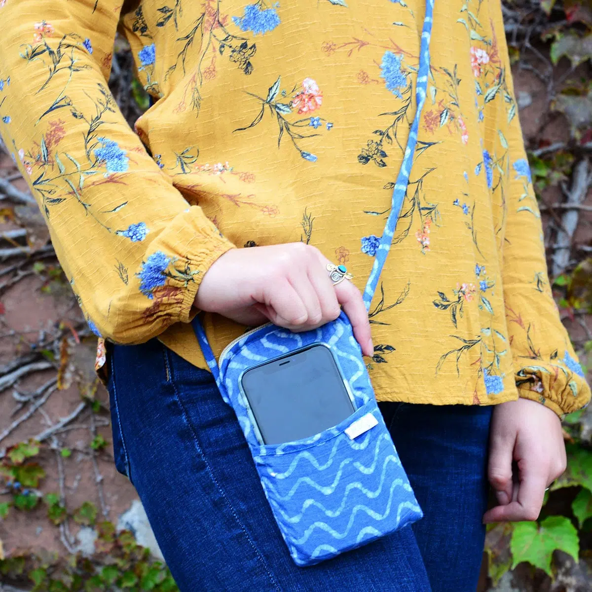Girl wearing blue natural dye phone pouch