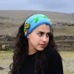A young women wearing a headband meant to cover her ears