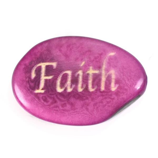 A tagua seed that says faith on it