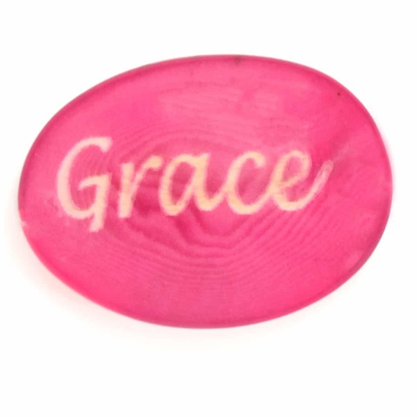 A tagua seed that says grace on it