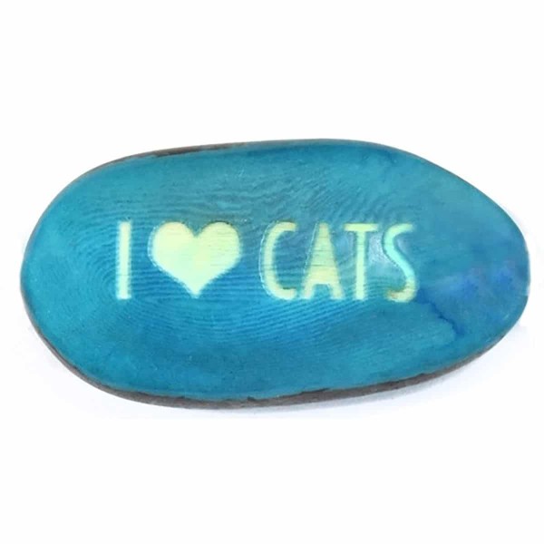 A tagua seed that says I ❤️ cats on it