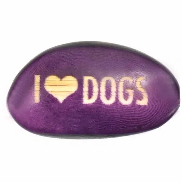 A tagua seed that says I ❤️ dogs on it