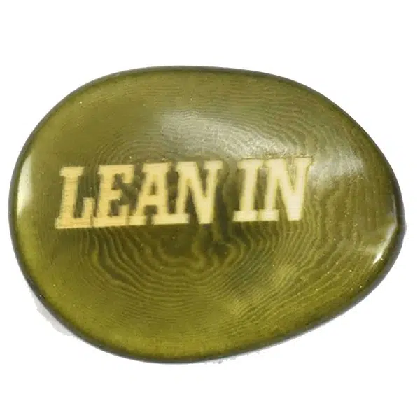 A tagua seed that says lean in on it