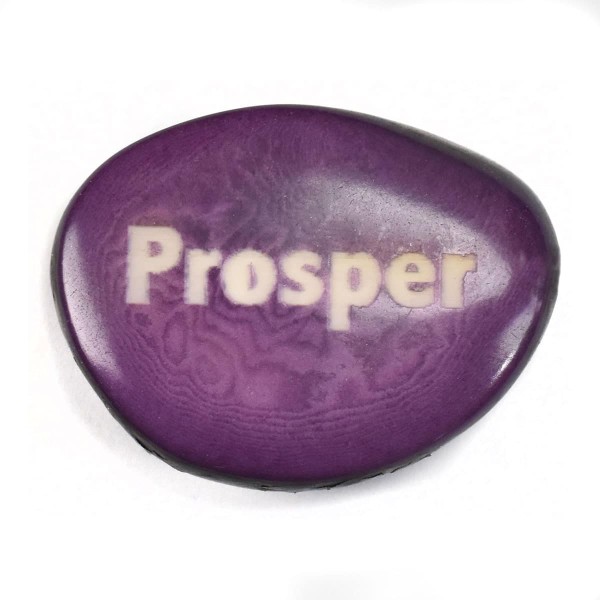 A tagua seed that says prosper on it