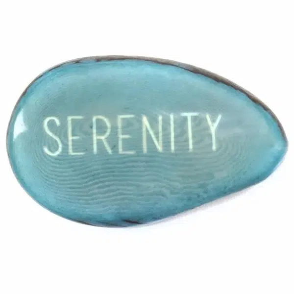 A tagua seed that says serenity on it