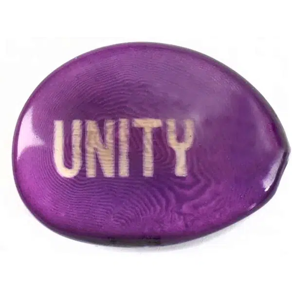 A tagua seed that says unity on it