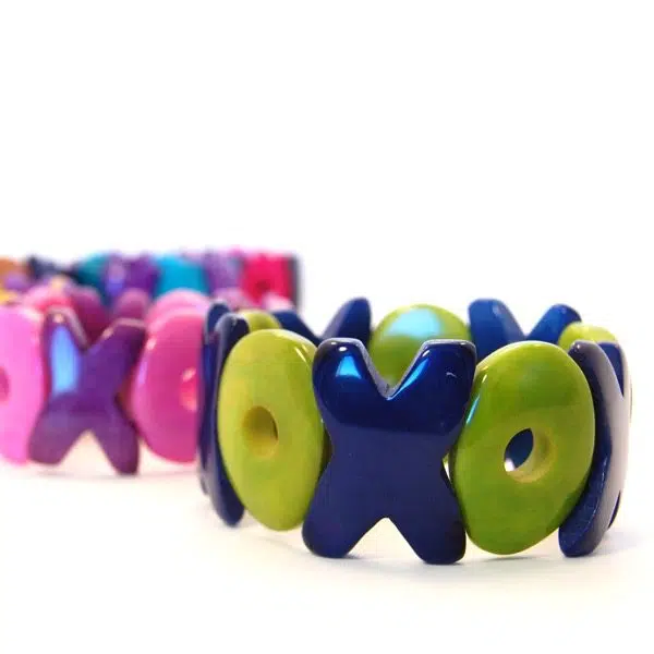 A close up picture of the XO tagua bracelet, the color of the bracelet is, Green/blue.