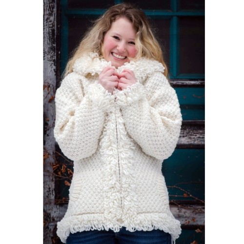 A young women wearing the boucle knit sweater, each sweater is hand knit