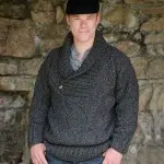 A young man wearing the cowl neck wool sweater, the sweater is made from sheep wool, and is available in navy and charcoal