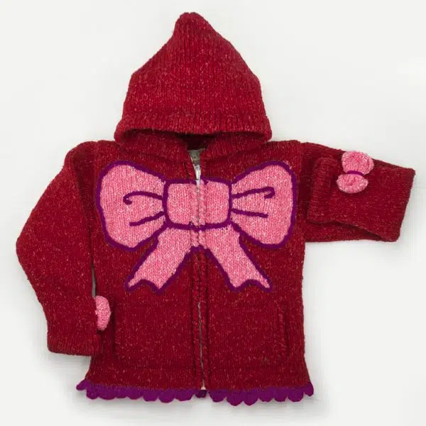 A red and pink sweater with a big bow in the middle and two small bows on the sides