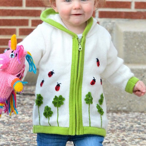 A young kid wearing the ladybug shuffle sweater