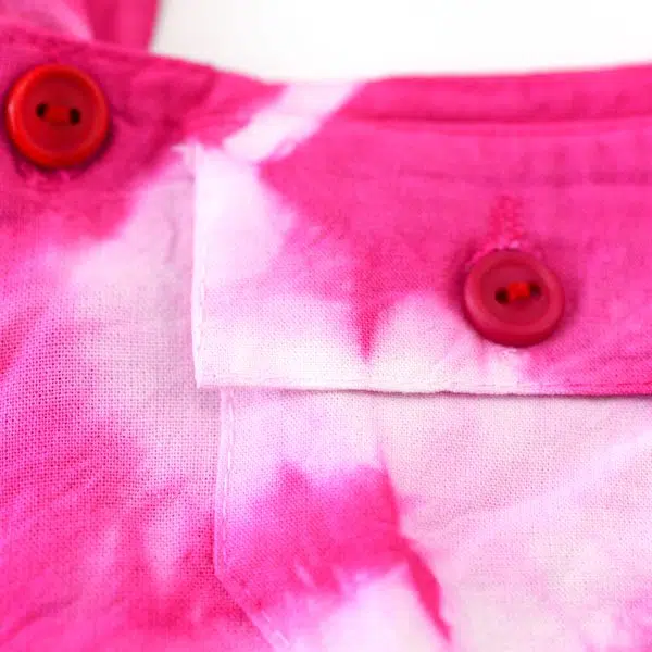 A close up of the short overalls, they come in different colors, they come in, pink, yellow, blue