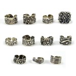 A picture of a wide verity of toe rings, all the toe rings have a verity of designs.