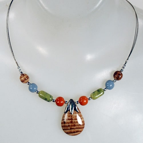 A picture of A necklace with nine polished stone, there are a verity of stones.