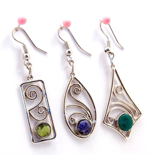 A close up picture of three different cabochon earrings.