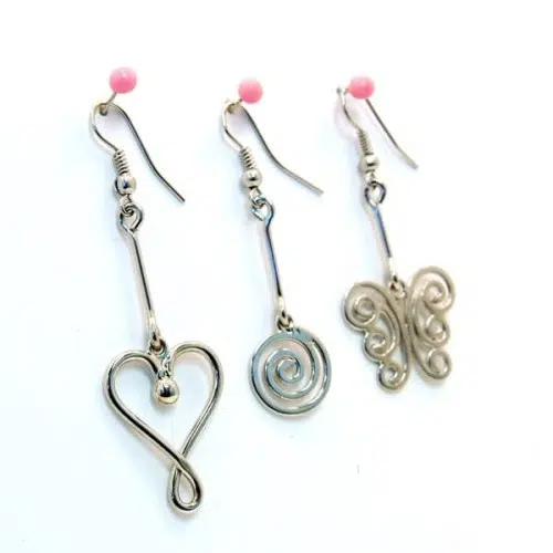 A picture of three different silhouette earrings that come in a heart style, spiral, and butterfly.