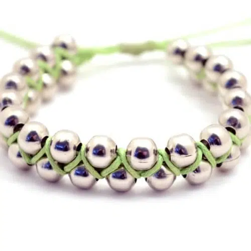 A close up of the bibi bracelet, made out of alpaca silver pearls, with an adjustable.