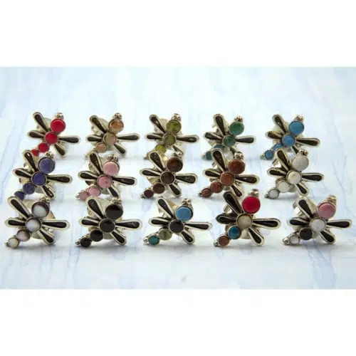 A picture of a bunch of different dragonfly rings, made from semi precious stones.