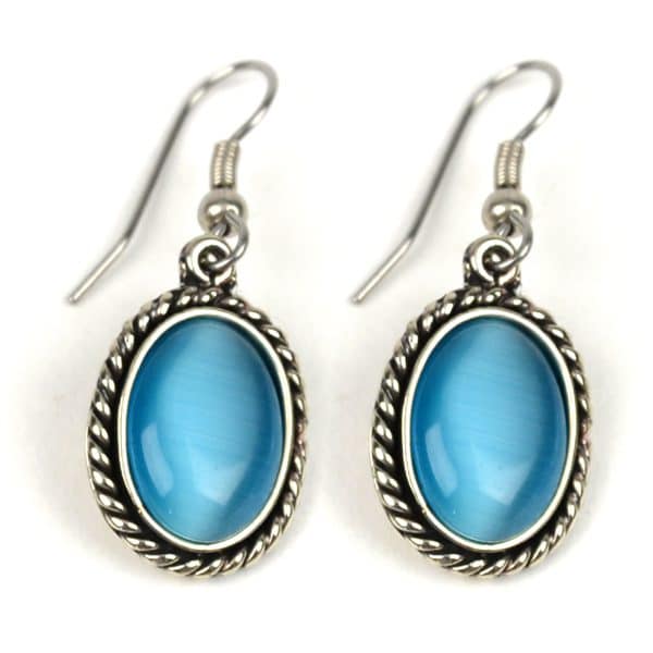 A close up picture of the cats eye earring, the color of the earring is turquoise