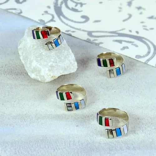A picture of some striped rings, made from alpaca silver and has some brightly colored semi precious stones on them.