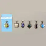 A picture of a bunch of framed necklaces, these necklaces come in a verity of colors, the colors in this picture are, green, white, blue, dark green, black, turquoise.