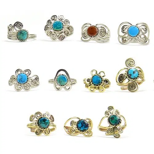 A picture of a bunch of different mixed metal ring, they come with a semi precious stone in the middle of the ring.
