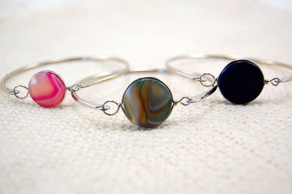 Three different styles of the top latch bracelet, those colors are pink, brown, and black.