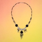 A close up picture of the stone chandelier necklace made from a black stone.