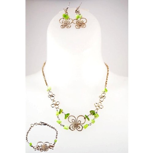 A picture of the alpaca butterfly set, made from metal and beading, this seat has a necklace, bracelet, and earrings.