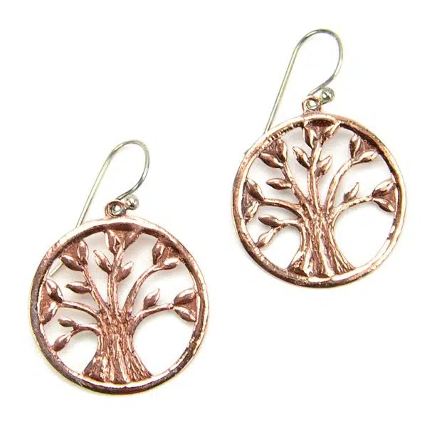 A close up of the pink vida earrings, with a pink tree in the middle of the earring.