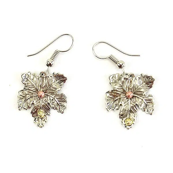 A picture of two silver maple leaf earrings