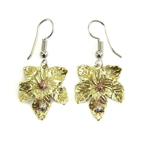 A picture of two gold maple leaf earrings