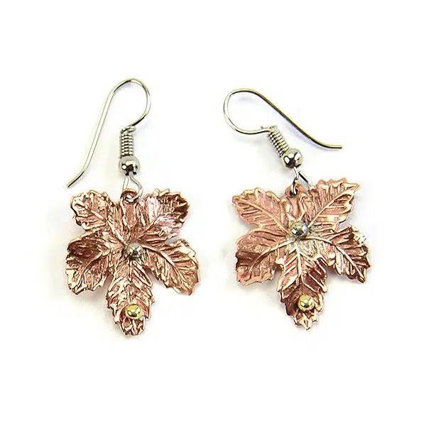 A picture of two bronze maple leaf earrings