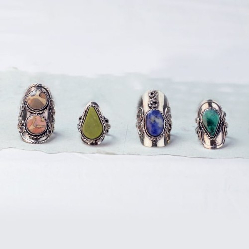 A picture of four different earth stone rings.