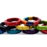 the cube bracelet has rectangular tagua beads on elastic, they come in a verity of colors, those colors are, red, multi, black, yellow, green, blue, turquoise, and purple.